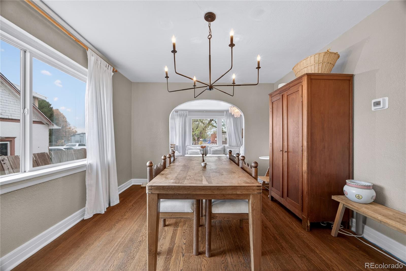6730 Oneida Street Commerce City, CO 80022 - Photo 11 of 37 a view of a dining room with furniture window and wooden floor