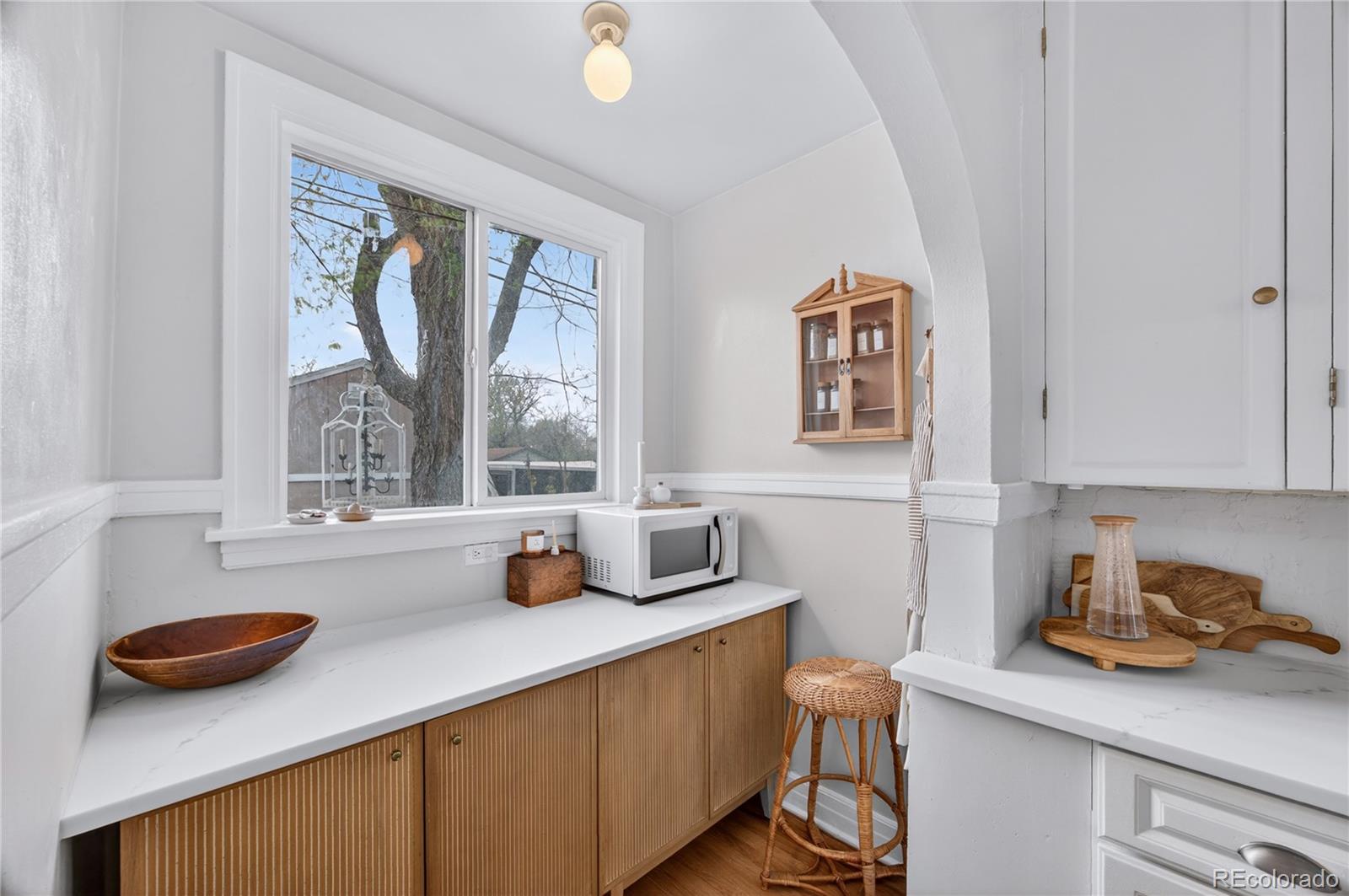 6730 Oneida Street Commerce City, CO 80022 - Photo 15 of 37 a kitchen with a sink a stove and a window