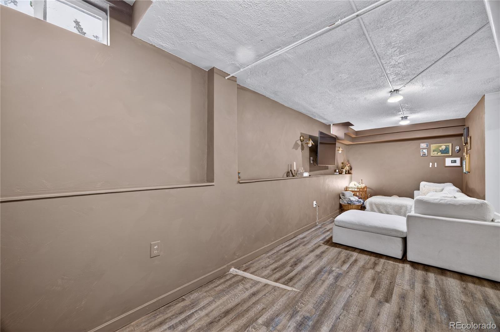 6730 Oneida Street Commerce City, CO 80022 - Photo 22 of 37 a living room with furniture and white walls