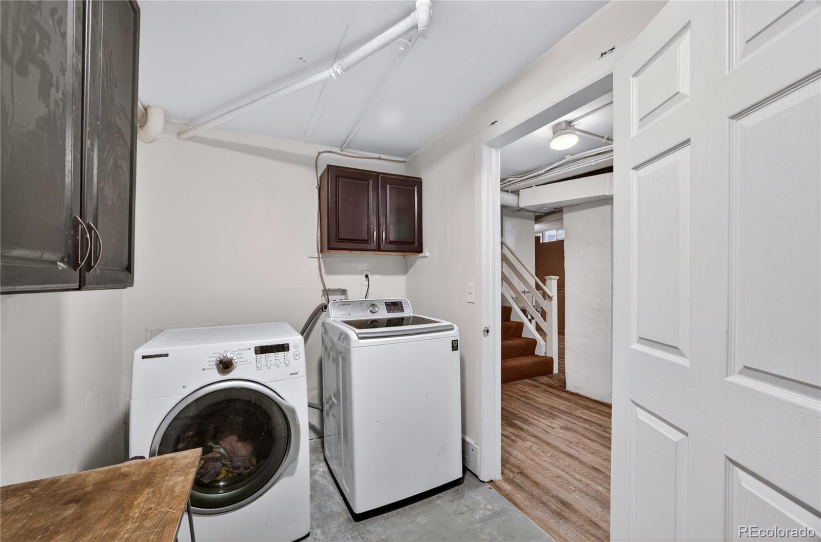6730 Oneida Street Commerce City, CO 80022 - Photo 25 of 37 a view of a kitchen with washer and dryer