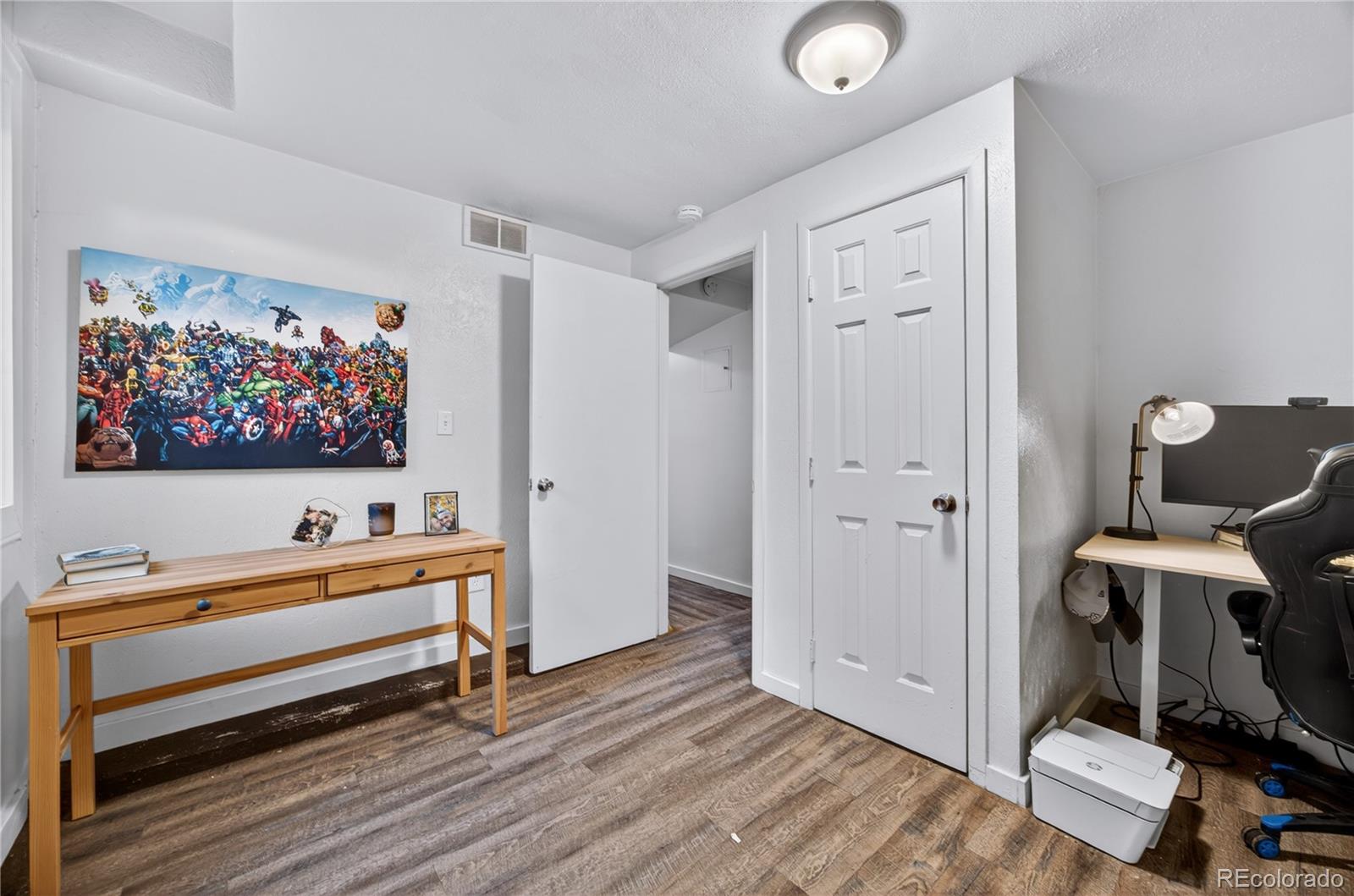 6730 Oneida Street Commerce City, CO 80022 - Photo 27 of 37 a room with furniture and wooden floor