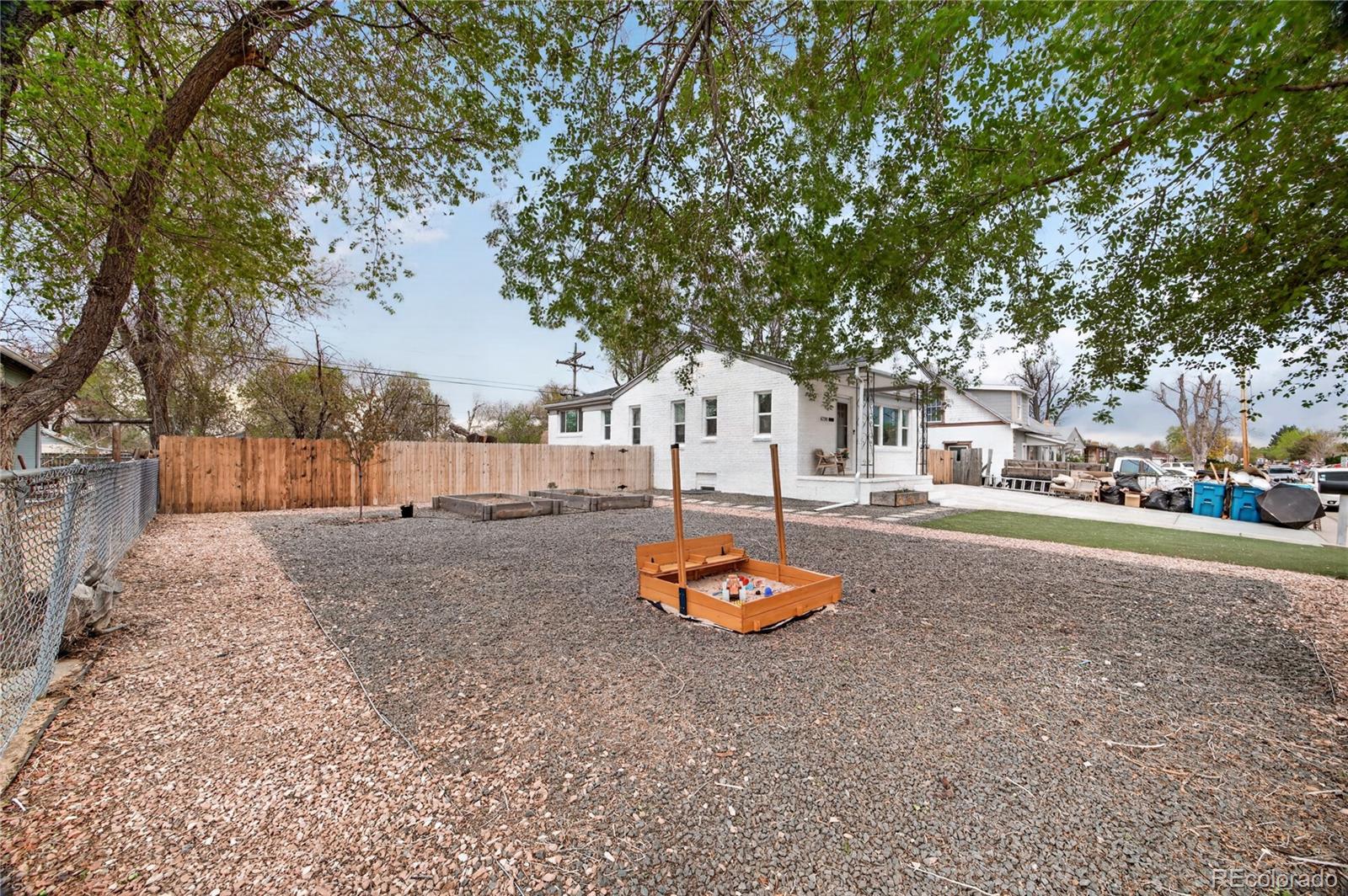 6730 Oneida Street Commerce City, CO 80022 - Photo 30 of 37 a backyard of a house with table and chairs
