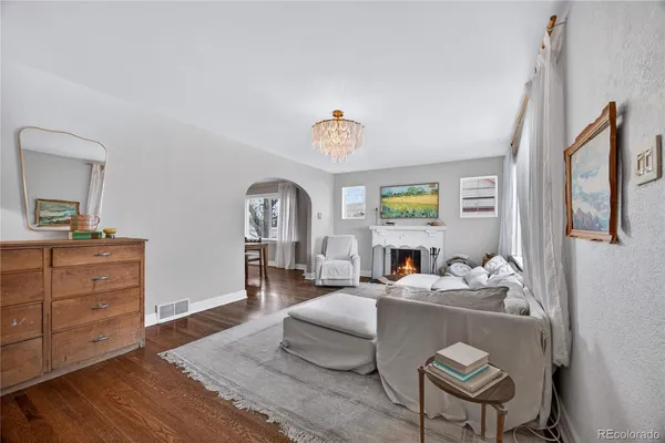 a living room with furniture and a chandelier