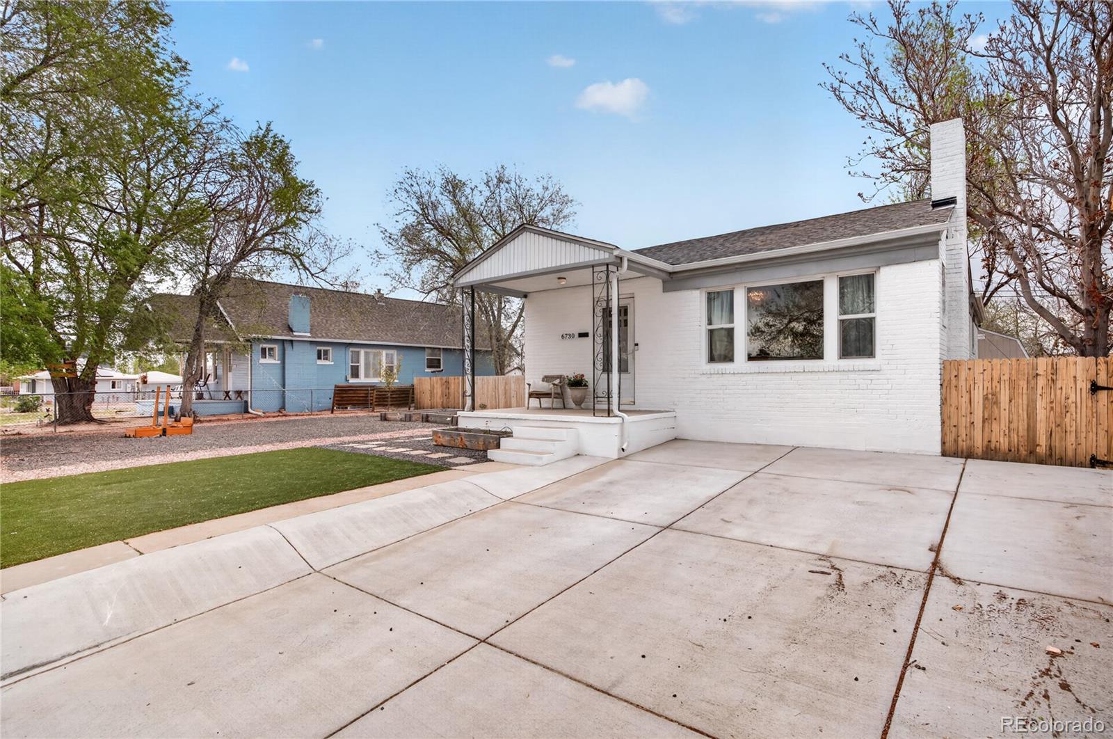 6730 Oneida Street Commerce City, CO 80022 - Photo 32 of 37 a view of a white house with a yard and plants