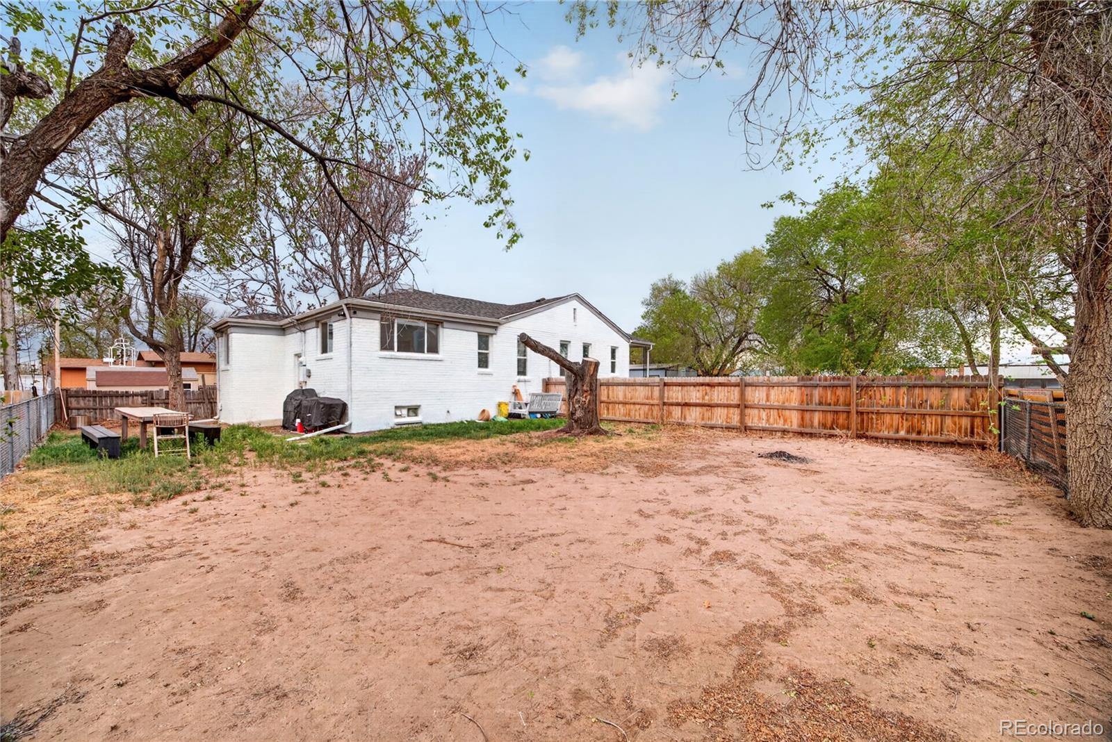 6730 Oneida Street Commerce City, CO 80022 - Photo 35 of 37 a view of a backyard with large trees
