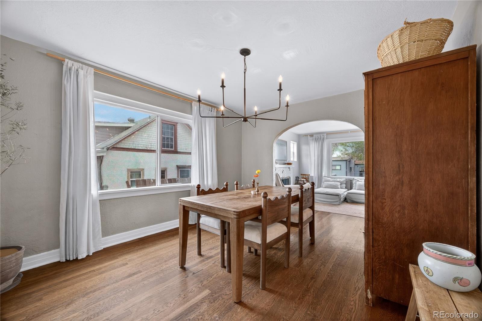 6730 Oneida Street Commerce City, CO 80022 - Photo 10 of 37 a dining room with furniture window and wooden floor