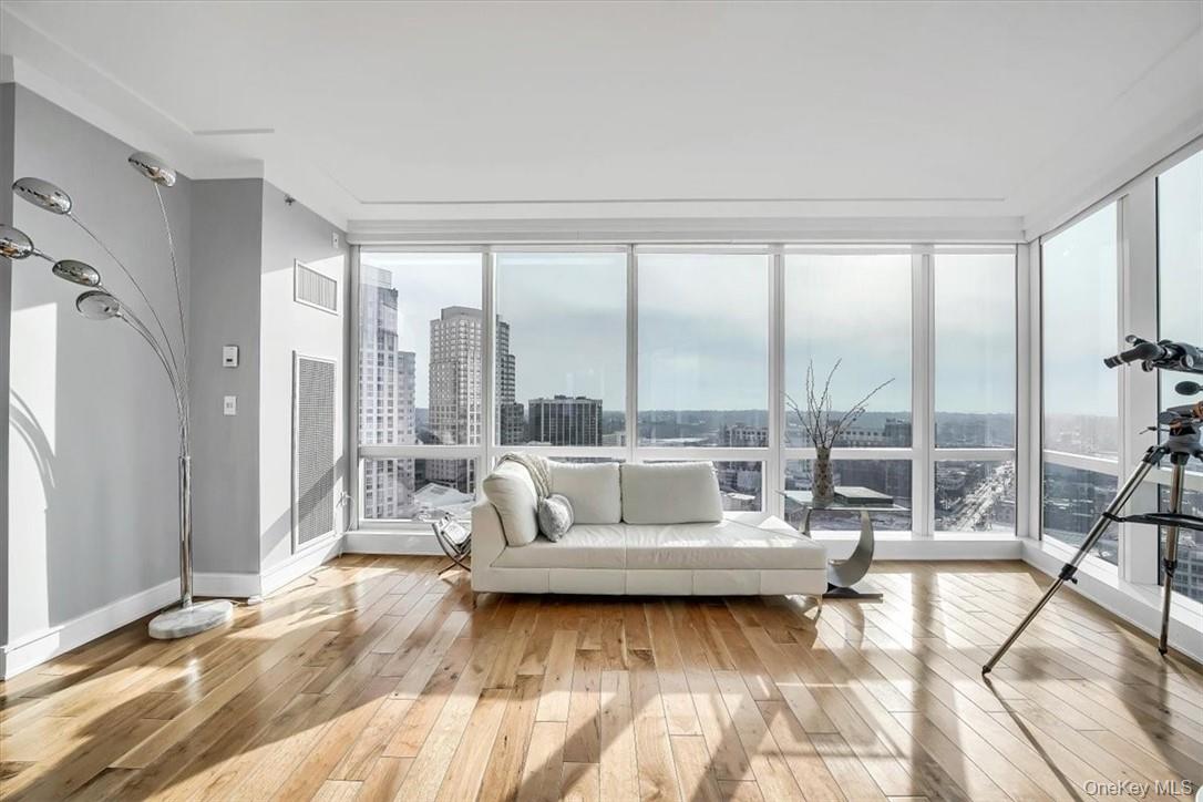 1 Renaissance Square, Unit 20C White Plains, NY 10601 - Photo 6 of 13 a living room with furniture and a large window with outer view