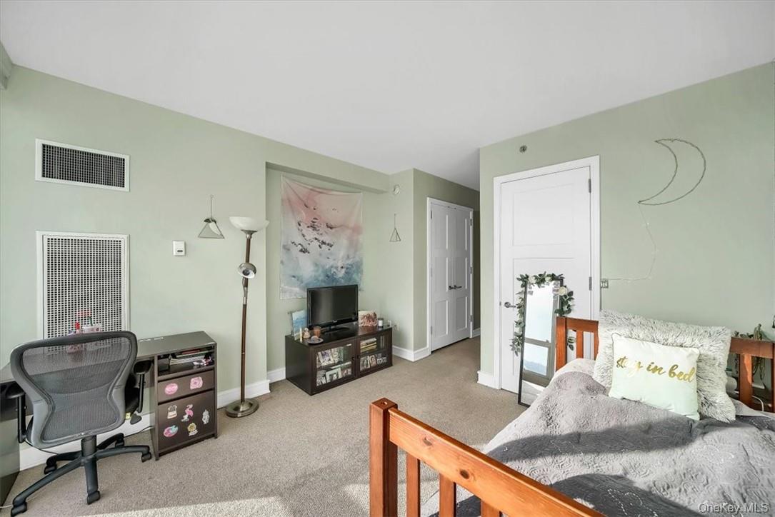 1 Renaissance Square, Unit 20C White Plains, NY 10601 - Photo 8 of 13 a bedroom with furniture and a bed
