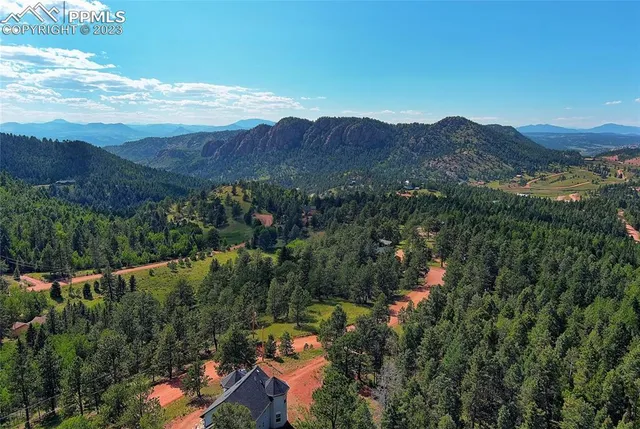 a view of a lush green hillside and houses