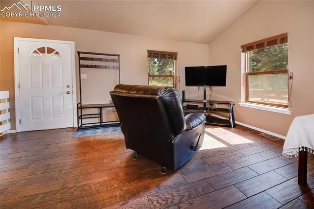 a living room with furniture and a flat screen tv