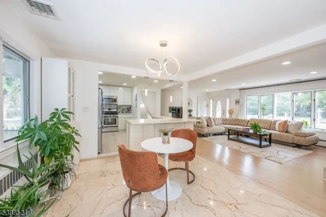 a view of a dining room with furniture and a large window