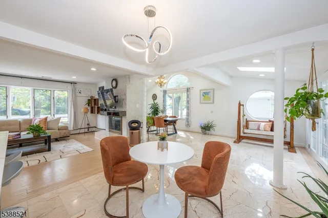 a living room with furniture potted plant and a large window