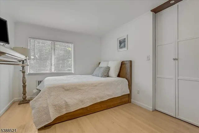 a large bed sitting in a bedroom next to a window