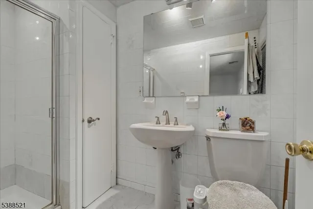 a bathroom with a sink mirror toilet and vanity
