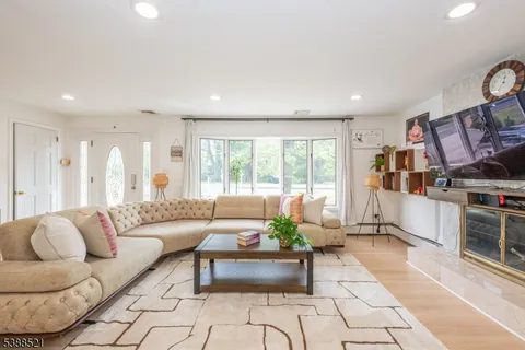 a living room with furniture and a book shelf