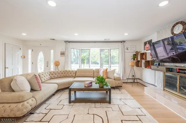 a living room with furniture and a book shelf