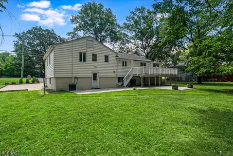 a view of a house with backyard and garden