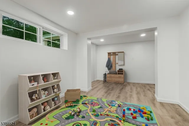 a living room with furniture and a book shelf