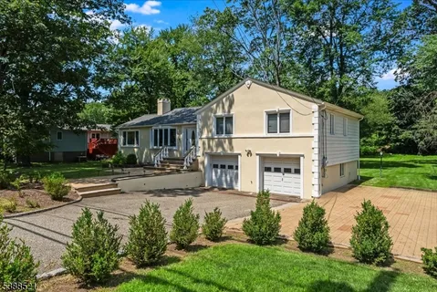 a view of house with yard and green space