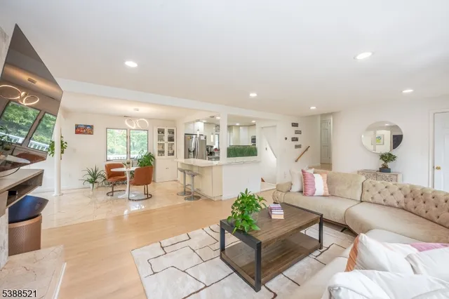 a living room with furniture a dining table and a large window