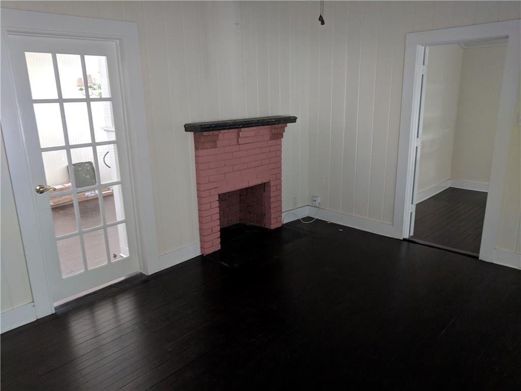 412 Southwest California Avenue Stuart, FL 34994 - Photo 35 of 46 a view of an empty room with wooden floor and a window