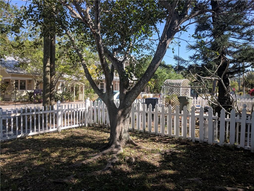 412 Southwest California Avenue Stuart, FL 34994 - Photo 44 of 46 a view of a yard with a large tree and wooden fence