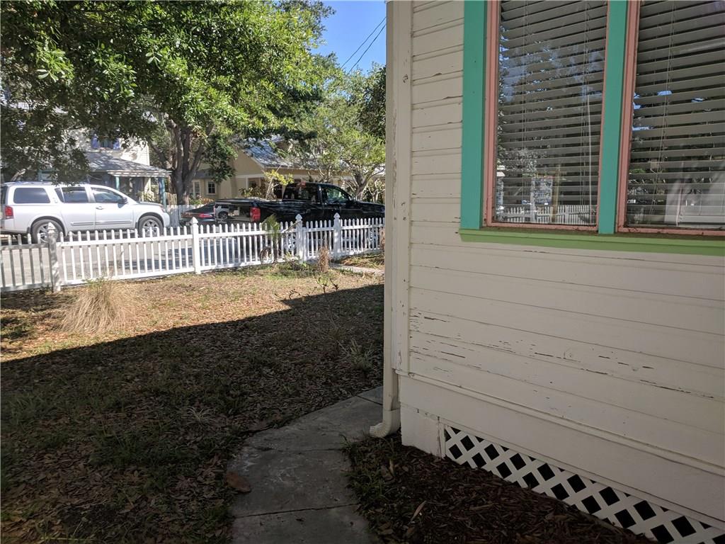 412 Southwest California Avenue Stuart, FL 34994 - Photo 6 of 46 a view of a house with a small yard and wooden fence