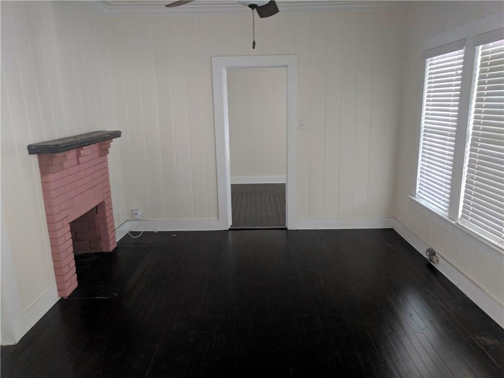 412 Southwest California Avenue Stuart, FL 34994 - Photo 8 of 46 an empty room with wooden floor and windows