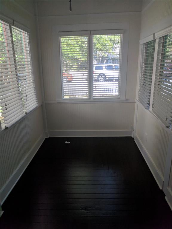 412 Southwest California Avenue Stuart, FL 34994 - Photo 10 of 46 a view of an empty room with wooden floor and a window