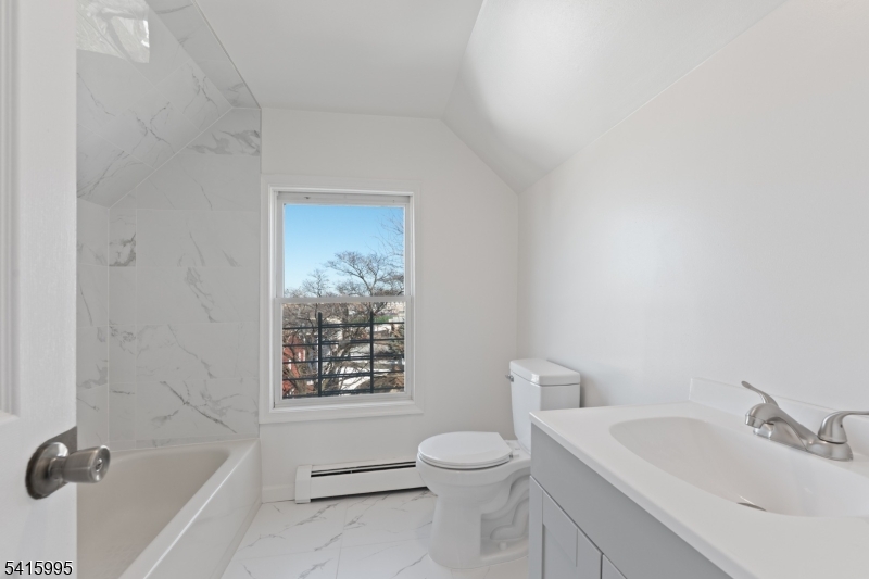 118 Ray Street Garfield, NJ 07026 - Photo 14 of 15 a bathroom with a sink toilet and shower