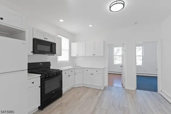 a kitchen with granite countertop a stove a sink and a granite counter tops