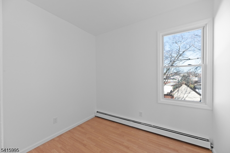 118 Ray Street Garfield, NJ 07026 - Photo 10 of 15 a view of a small space with wooden floor and a window