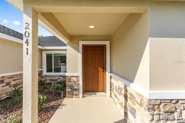 a bathroom with a granite countertop sink mirror and a bathtub
