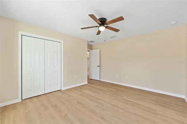 a view of a big house with a big yard and large trees