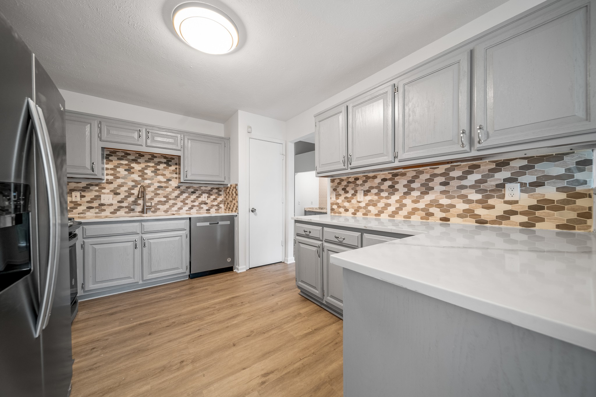 2417 Ravine Drive Nashville, TN 37217 - Photo 6 of 29 a kitchen with granite countertop white cabinets and white appliances