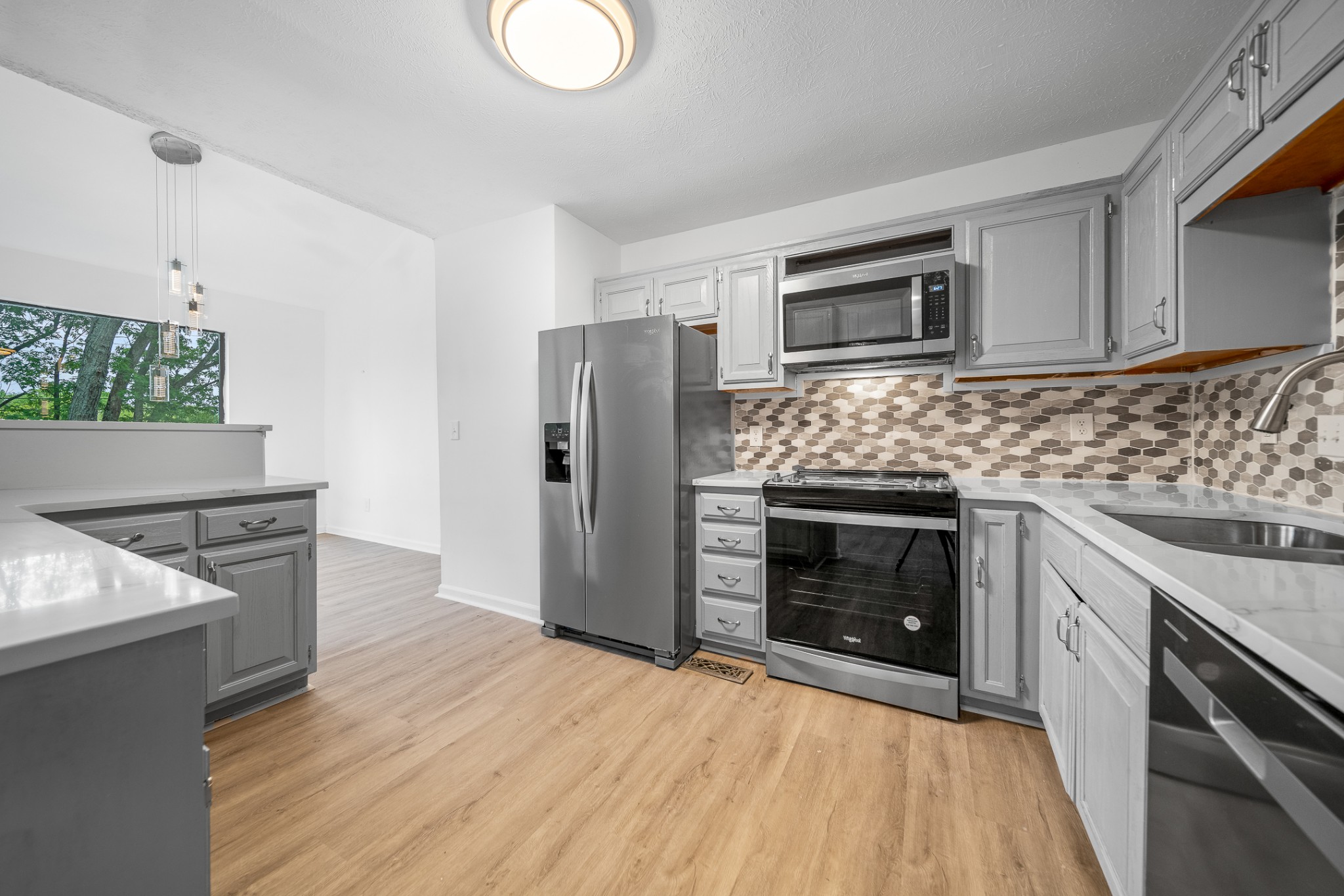 2417 Ravine Drive Nashville, TN 37217 - Photo 7 of 29 a kitchen with granite countertop wooden cabinets and stainless steel appliances