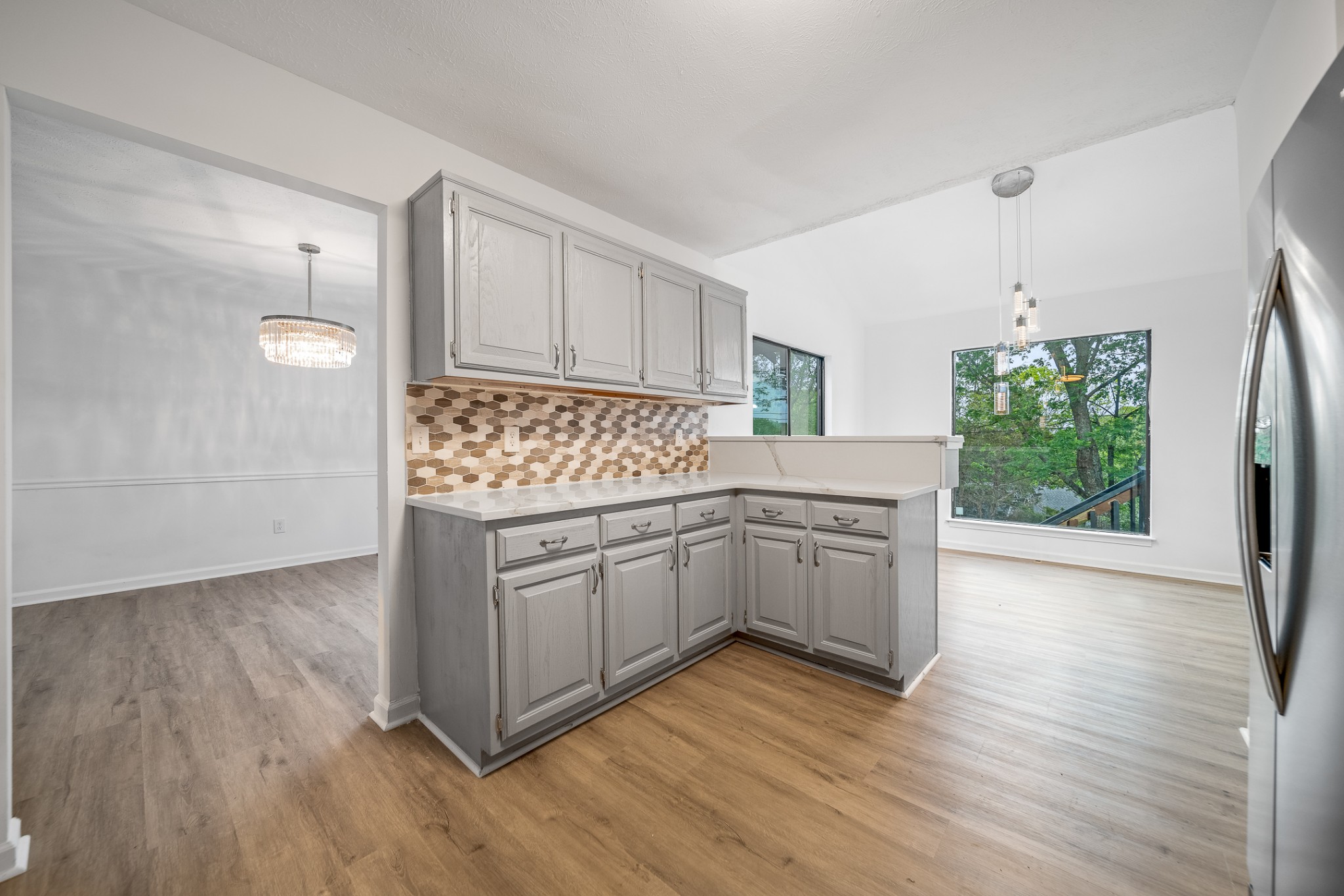 2417 Ravine Drive Nashville, TN 37217 - Photo 8 of 29 a kitchen with stainless steel appliances granite countertop wooden floors and white cabinets