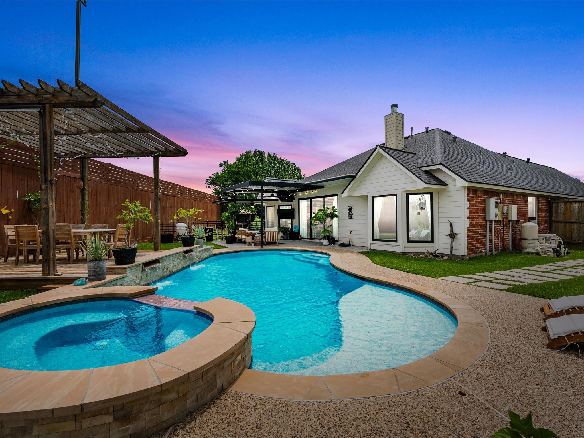 4023 Tigris Ridge Drive Katy, TX 77449 - Photo 2 of 39 The resort-style backyard features a sparkling pool and spa, dual pergolas, and an enhanced 11.5 ft privacy fence (2025–2026), creating a true private retreat.