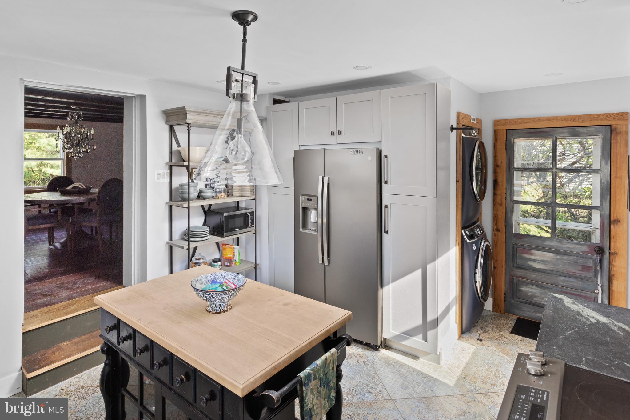 942 Province Line Road Allentown, NJ 08501 - Photo 25 of 50 a kitchen that has a refrigerator a stove and a dining table with wooden floor