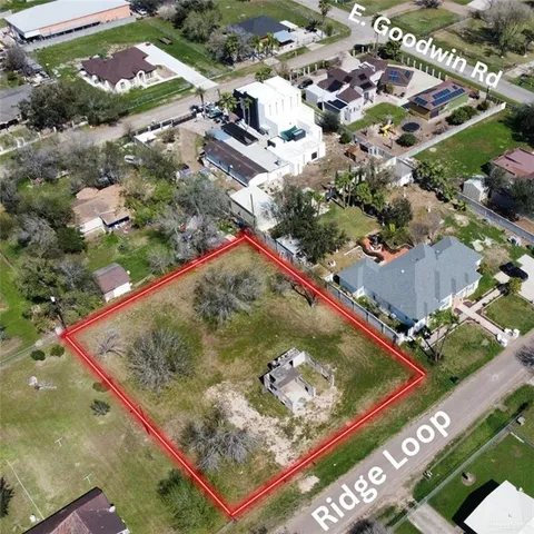 an aerial view of a residential houses with street