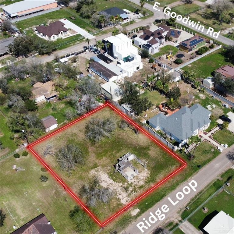 an aerial view of a residential houses with street