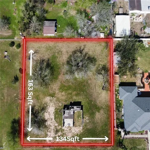 an aerial view of a residential houses with outdoor space