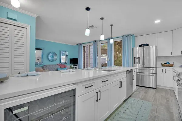 a kitchen with refrigerator and sink