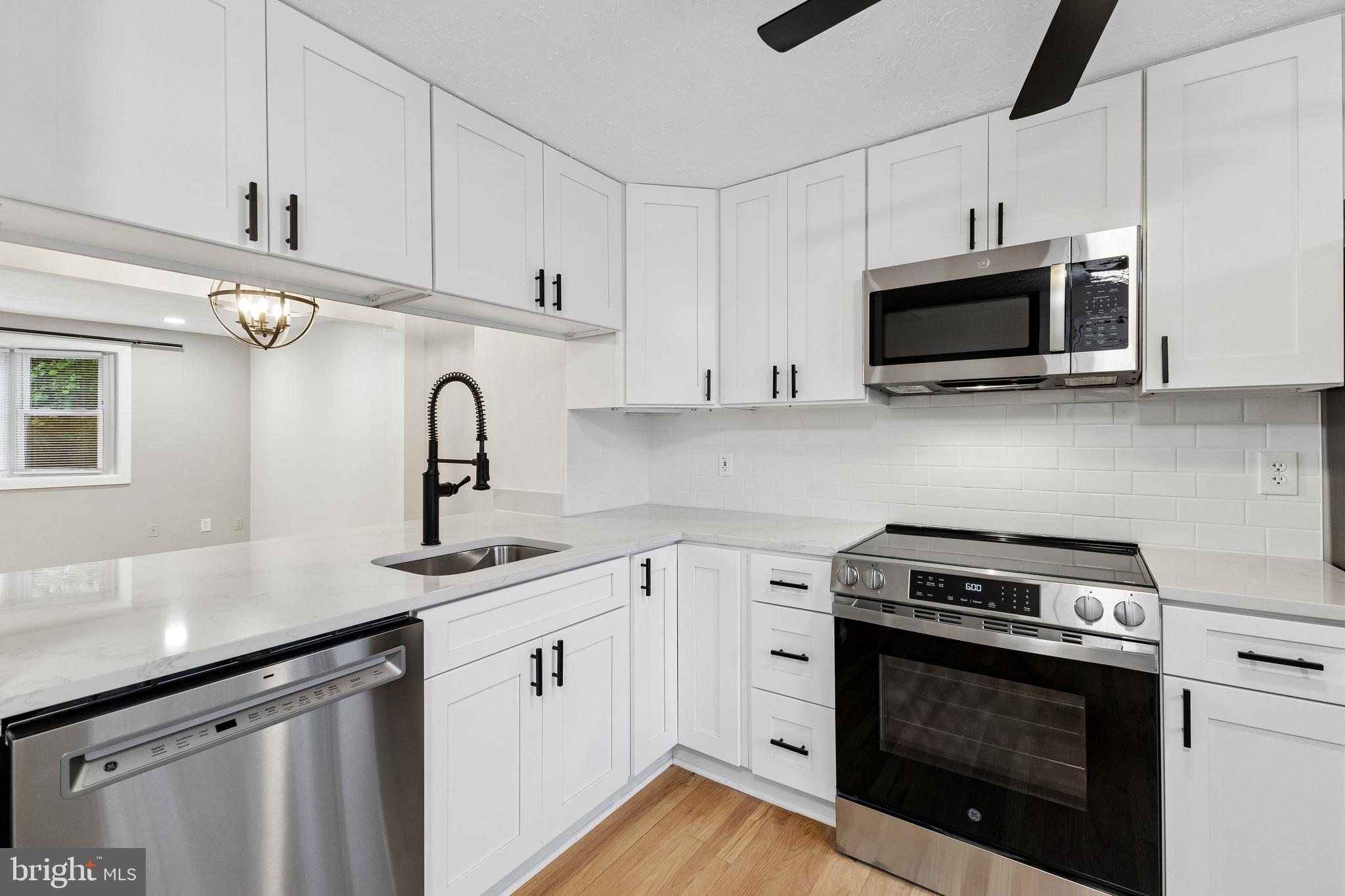 8317 Brookvale Court Springfield, VA 22153 - Photo 14 of 33 a kitchen with stainless steel appliances granite countertop grey cabinets a stove a sink and dishwasher