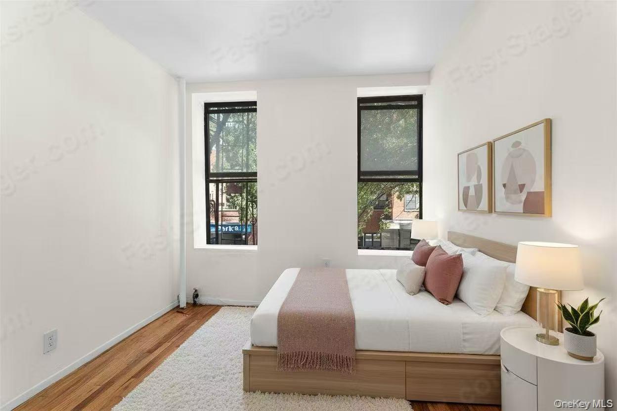 246 East 51st Street, Unit 7 Manhattan, NY 10022 - Photo 6 of 9 a bedroom with a bed and a window