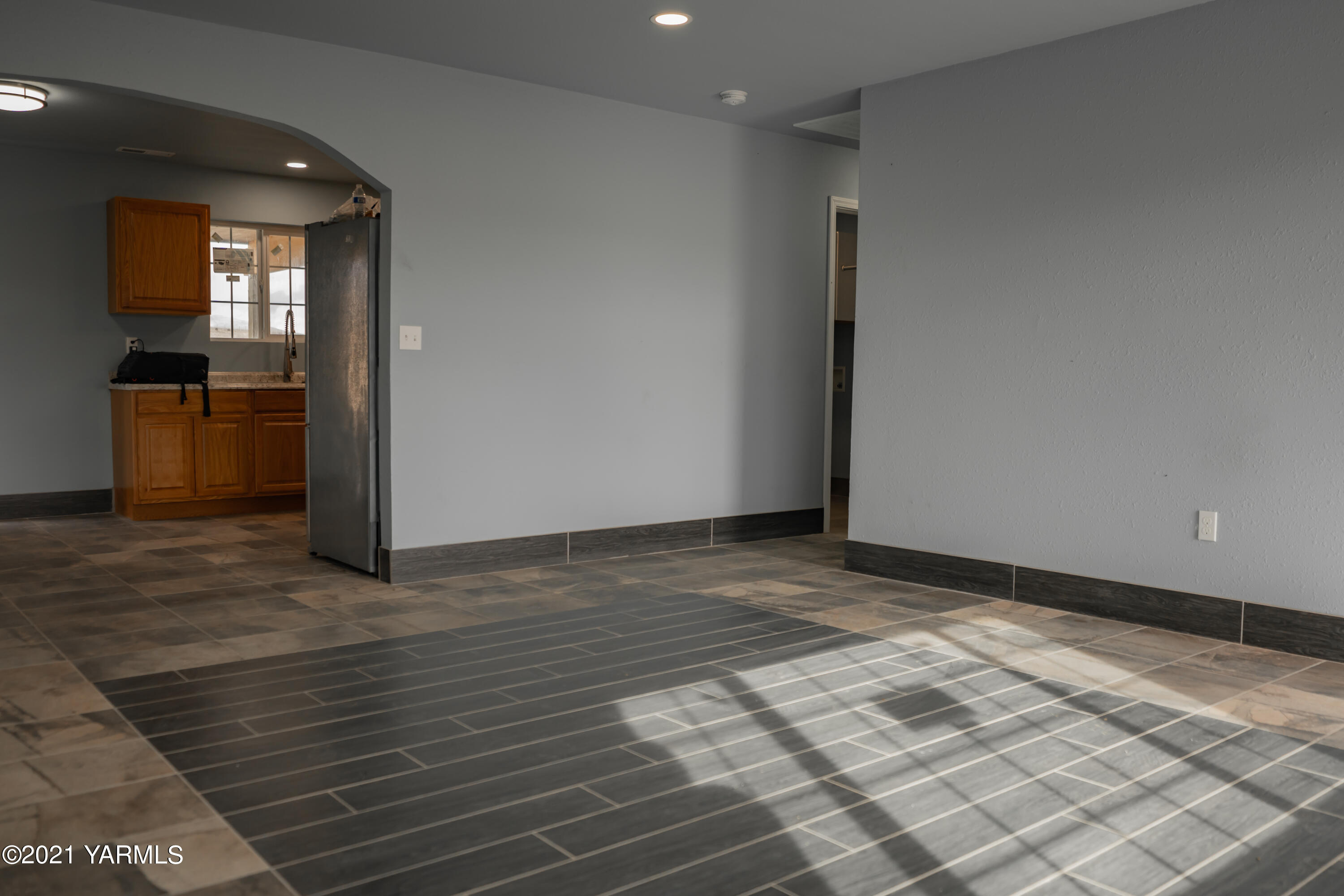 281 Starview Road Yakima, WA 98908 - Photo 6 of 26 a view of a hallway with wooden floor and a living room