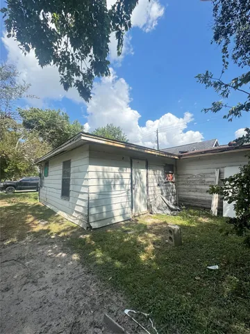 a backyard of a house with table and chairs
