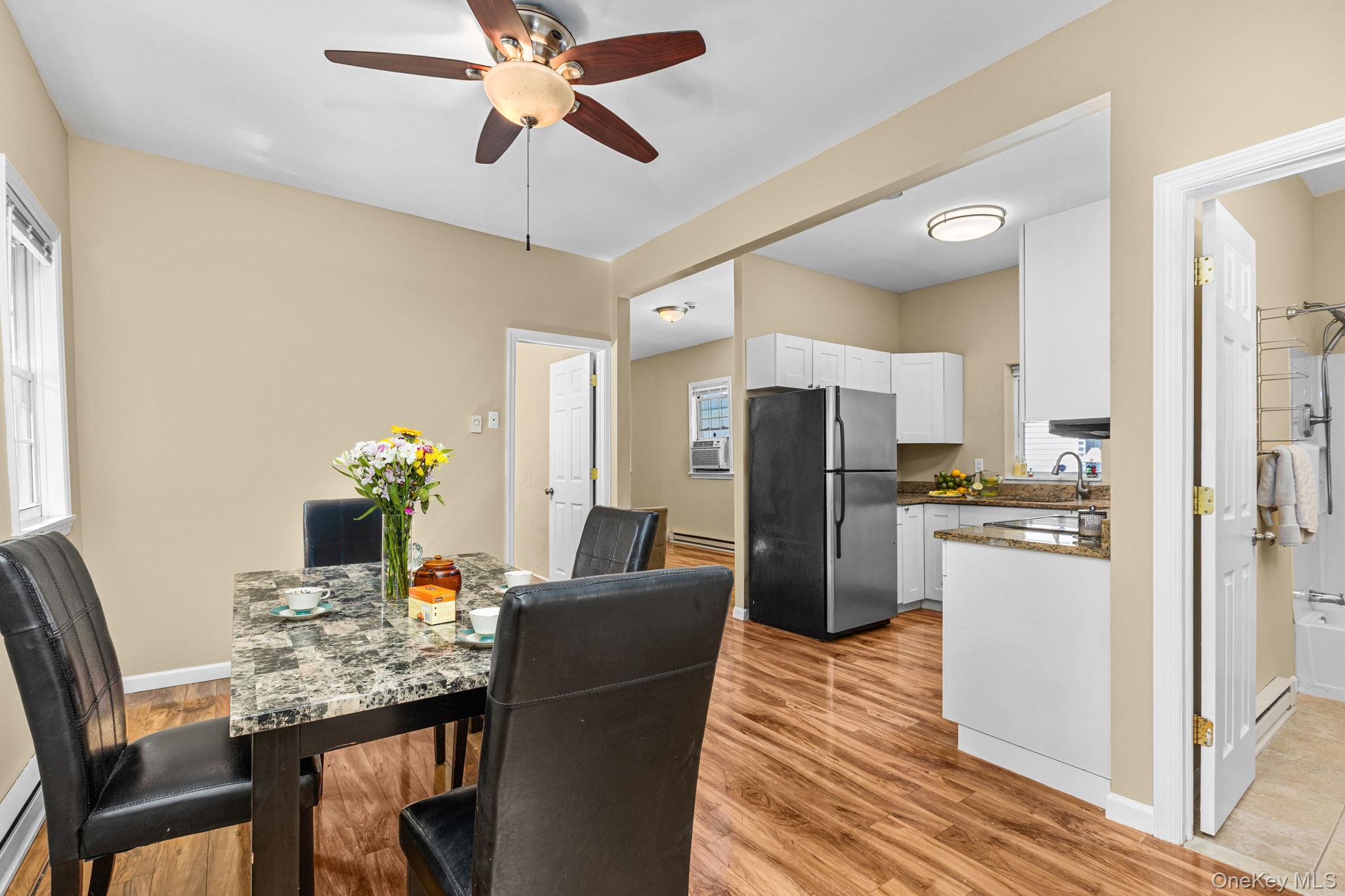 10 Batavia Road Patterson, NY 12563 - Photo 17 of 42 Open-concept living space featuring wood-finish flooring, a ceiling fan with integrated lighting, and neutral wall tones