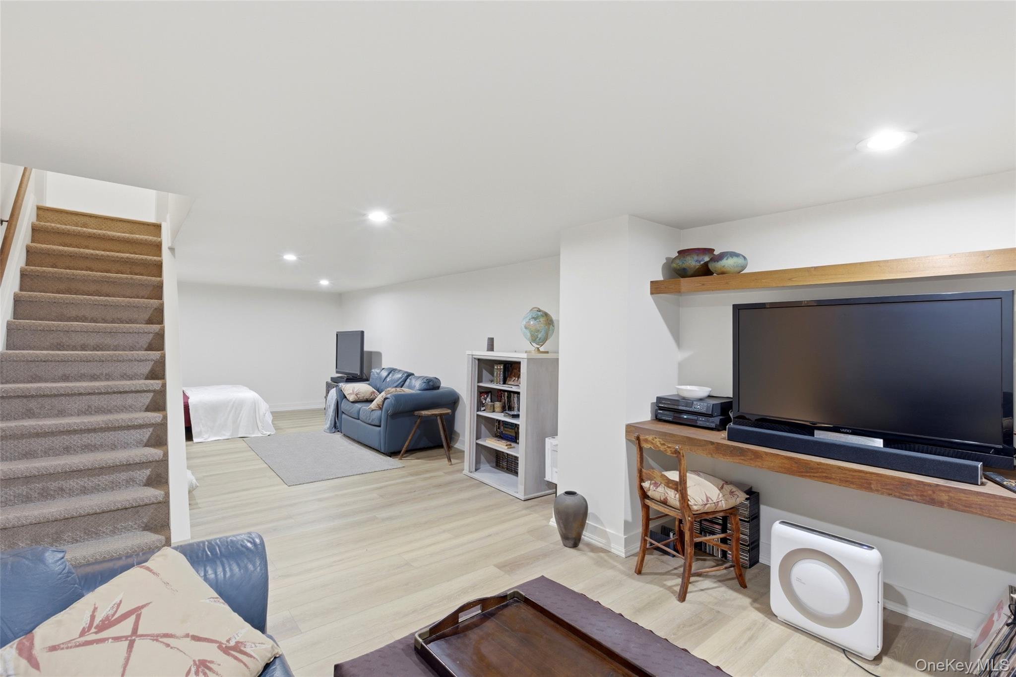 7 Gun Path Setauket, NY 11733 - Photo 27 of 34 a living room with furniture and a flat screen tv
