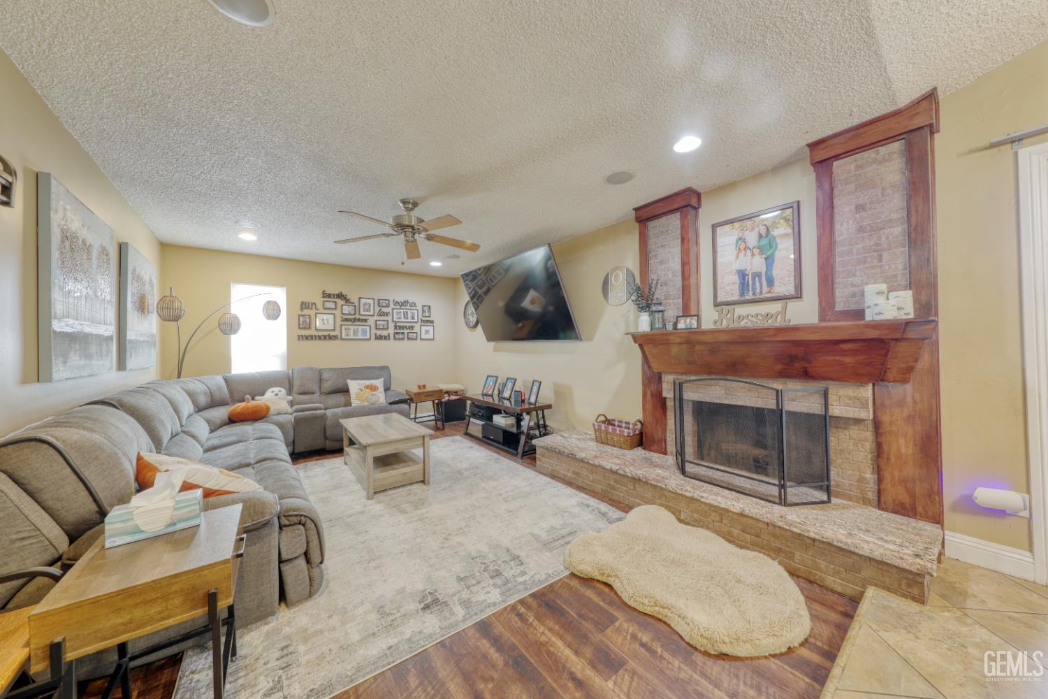 Undisclosed Address Bakersfield, CA 93308 - Photo 11 of 64 a living room with furniture a fireplace and a flat screen tv